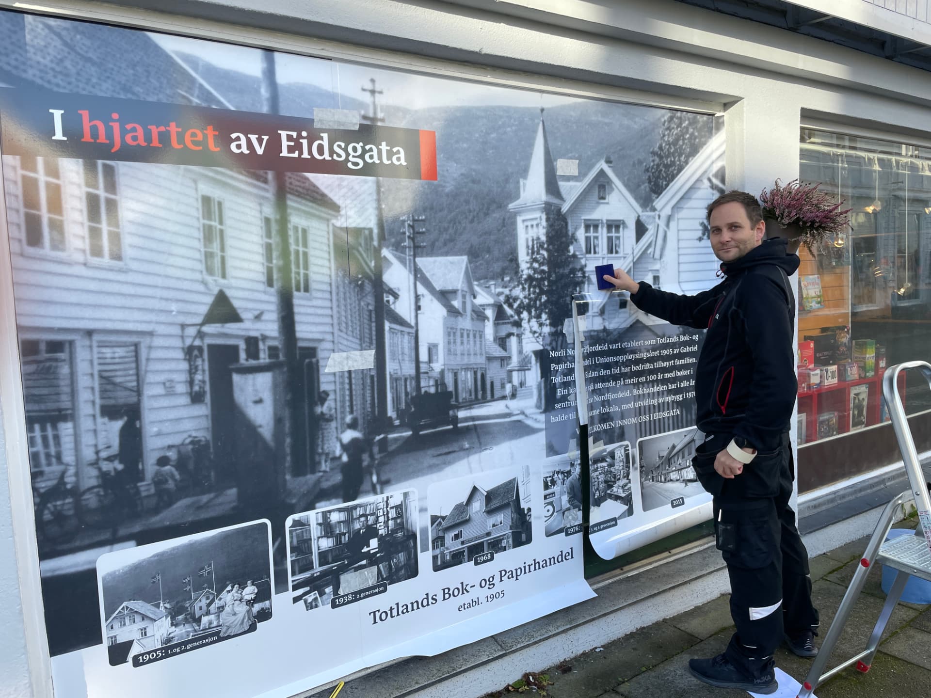 Montering av folie på butikkvinduet til Totland Bokhandel